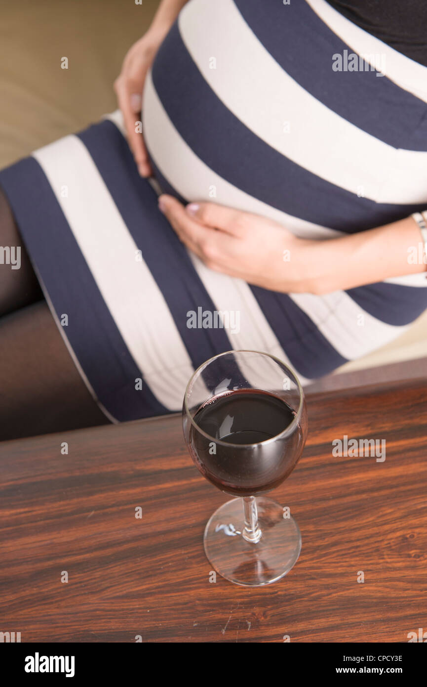 A glass of red wine and a pregnant woman Stock Photo Alamy