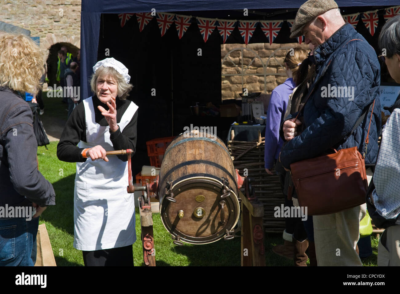 Demonstration of butter churning from the Victorian era at Ludlow Spring Food Festival Stock Photo