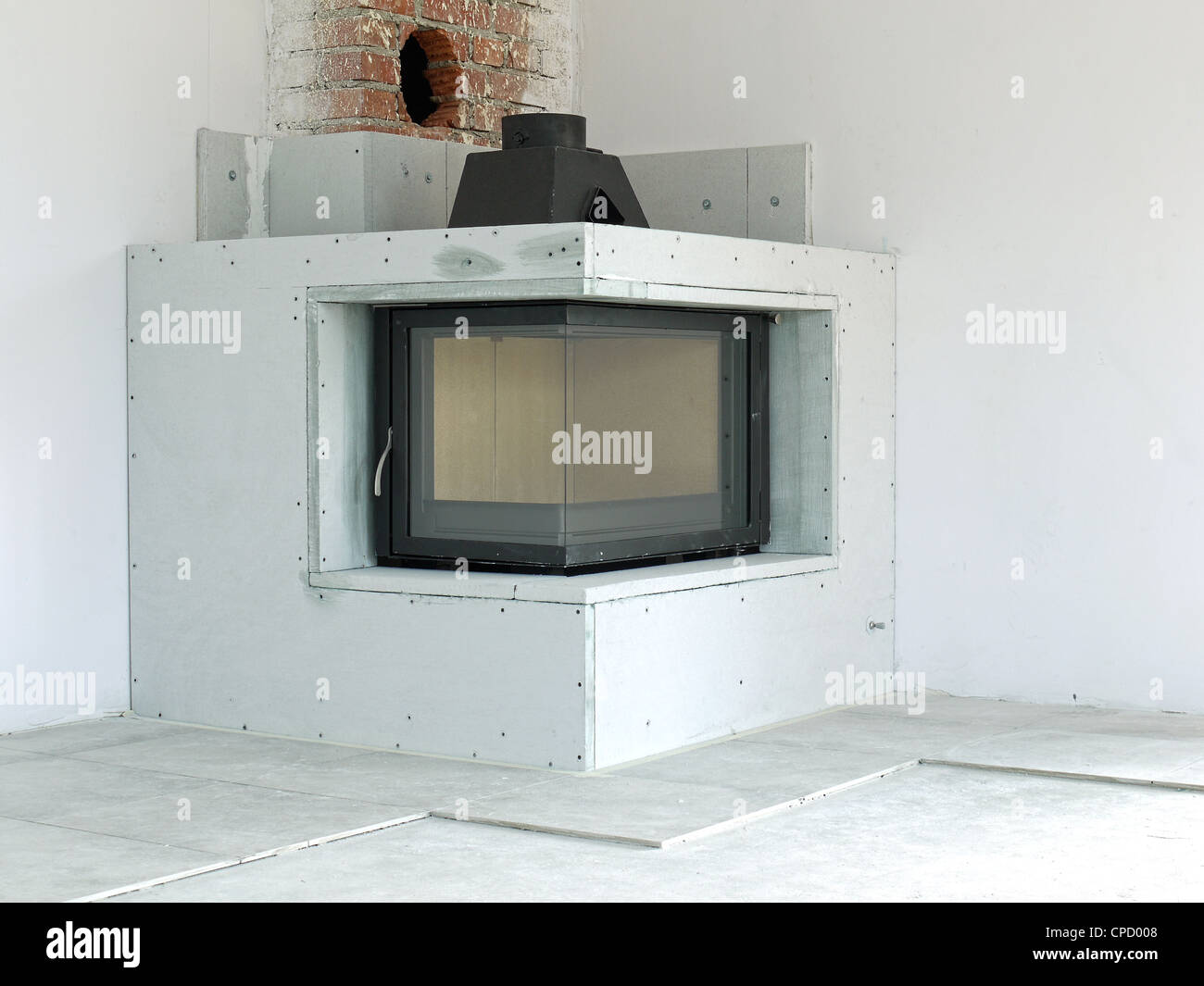 Modern corner wood-fired fireplace under construction Stock Photo