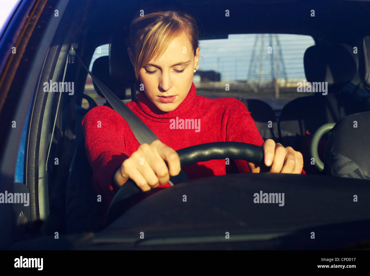 Woman falling asleep at the wheel Stock Photo