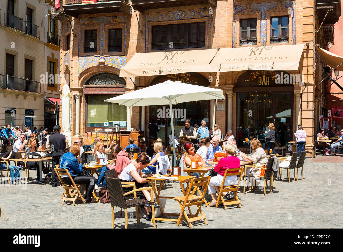 Europe, Spain Andalusia, Sevilla, Outdoor cafes and tourists in Plaza de San Francisco Stock Photo