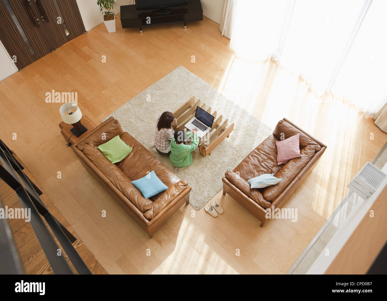 Mother and son looking at laptop in a living room Stock Photo - Alamy