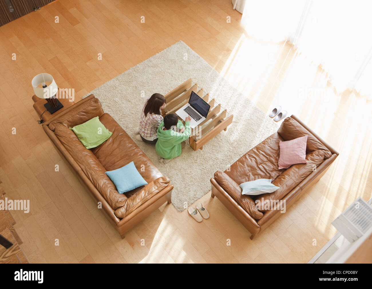Mother and son looking at laptop in a living room Stock Photo - Alamy