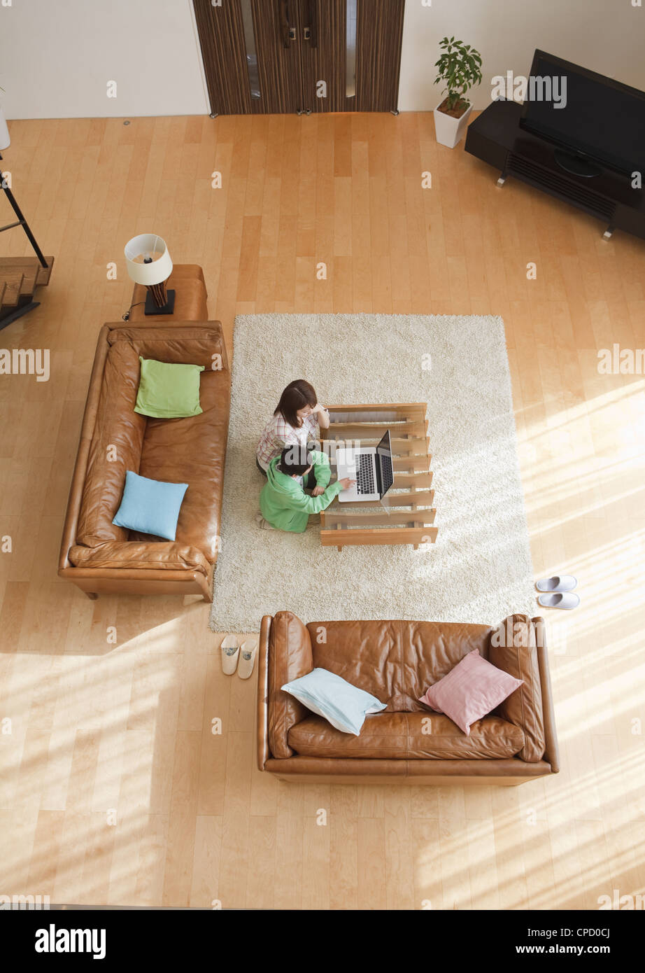Mother and son looking at laptop in a living room Stock Photo - Alamy