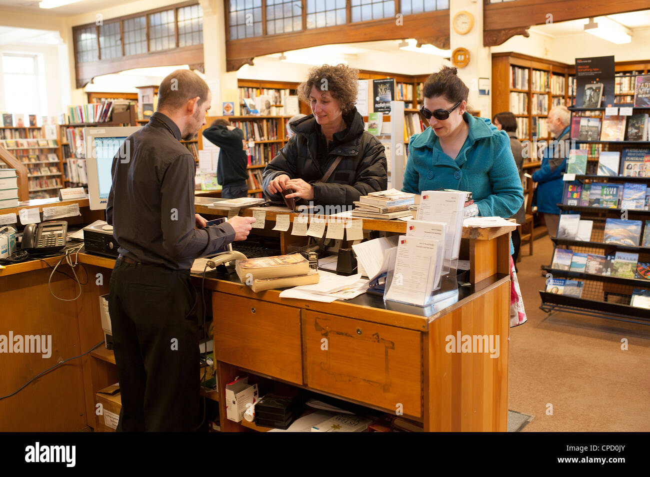 A librarian issuing books in the old Aberystwyth Carnegie funded public