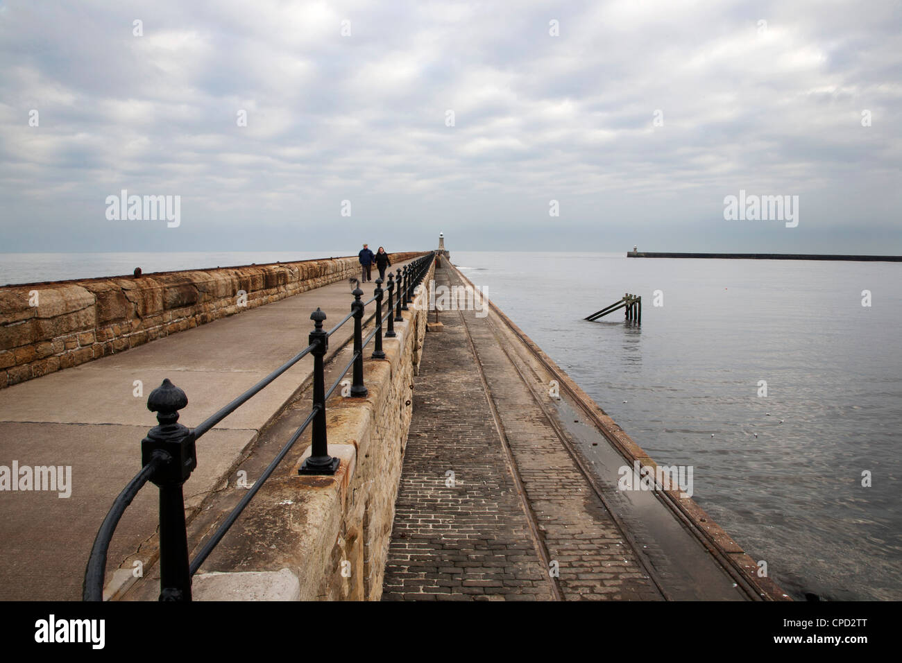 Couple walking on the North Pier at Tynemouth, North Tyneside, Tyne and Wear, England, United Kingdom, Europe Stock Photo