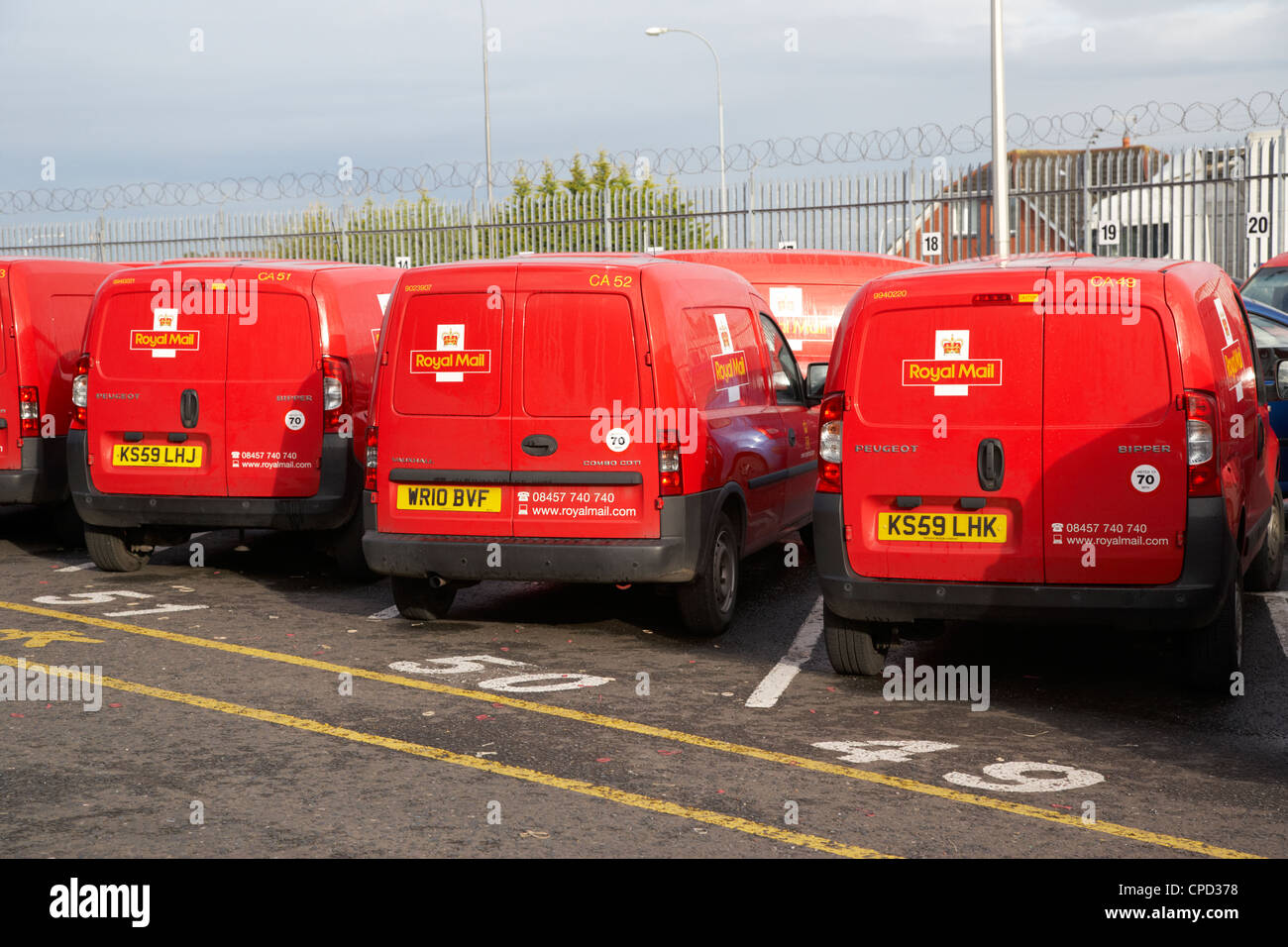 row of royal mail vans in a mail centre in the uk Stock Photo