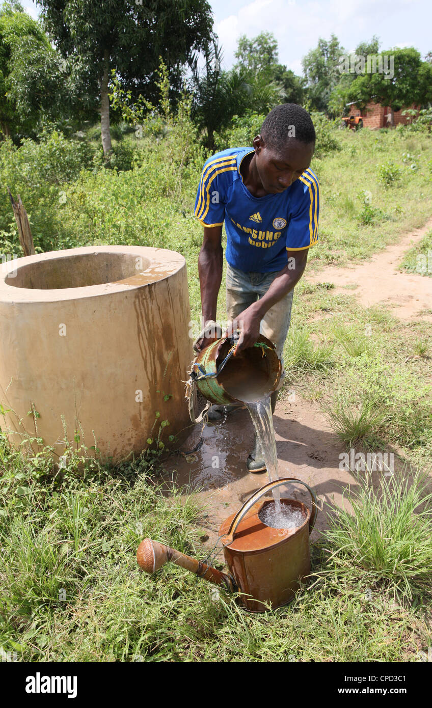 Man fetching water from well, Tori, Benin, West Africa, Africa Stock Photo
