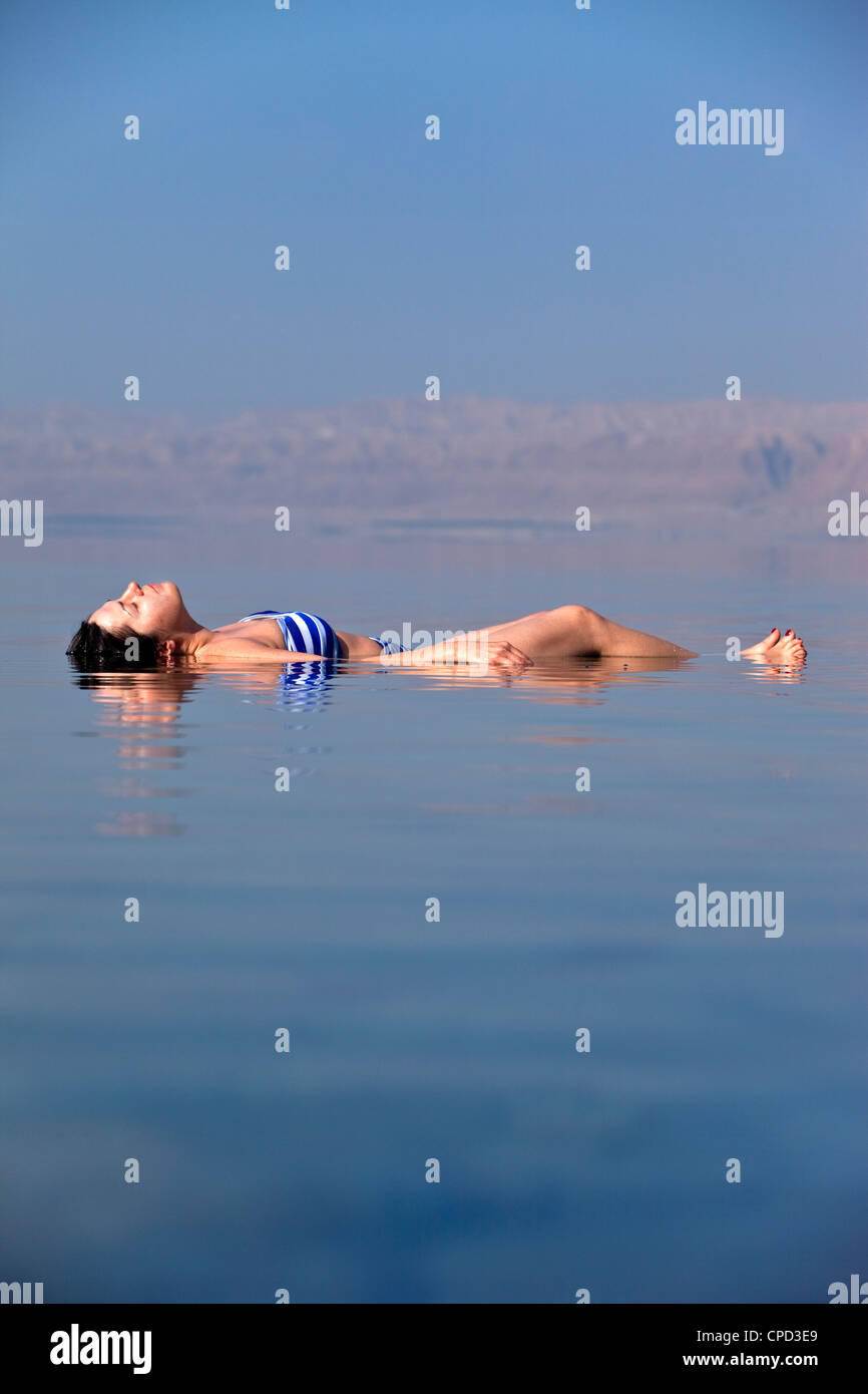 Young woman floating in the Dead Sea, Movenpick Resort Hotel, Jordan, Western Asia Stock Photo