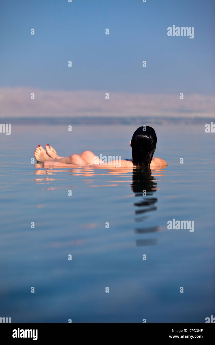 Young woman floating in the Dead Sea, Movenpick Resort Hotel, Jordan, Western Asia Stock Photo