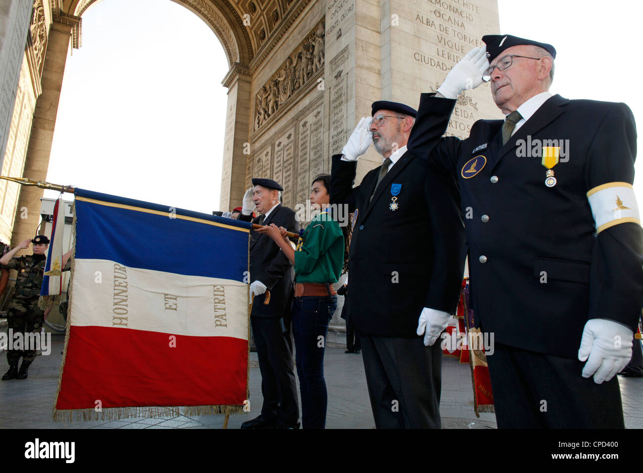 French Muslim girl scout and war veterans at the Arc de Triomphe, Paris, France, Europe Stock Photo