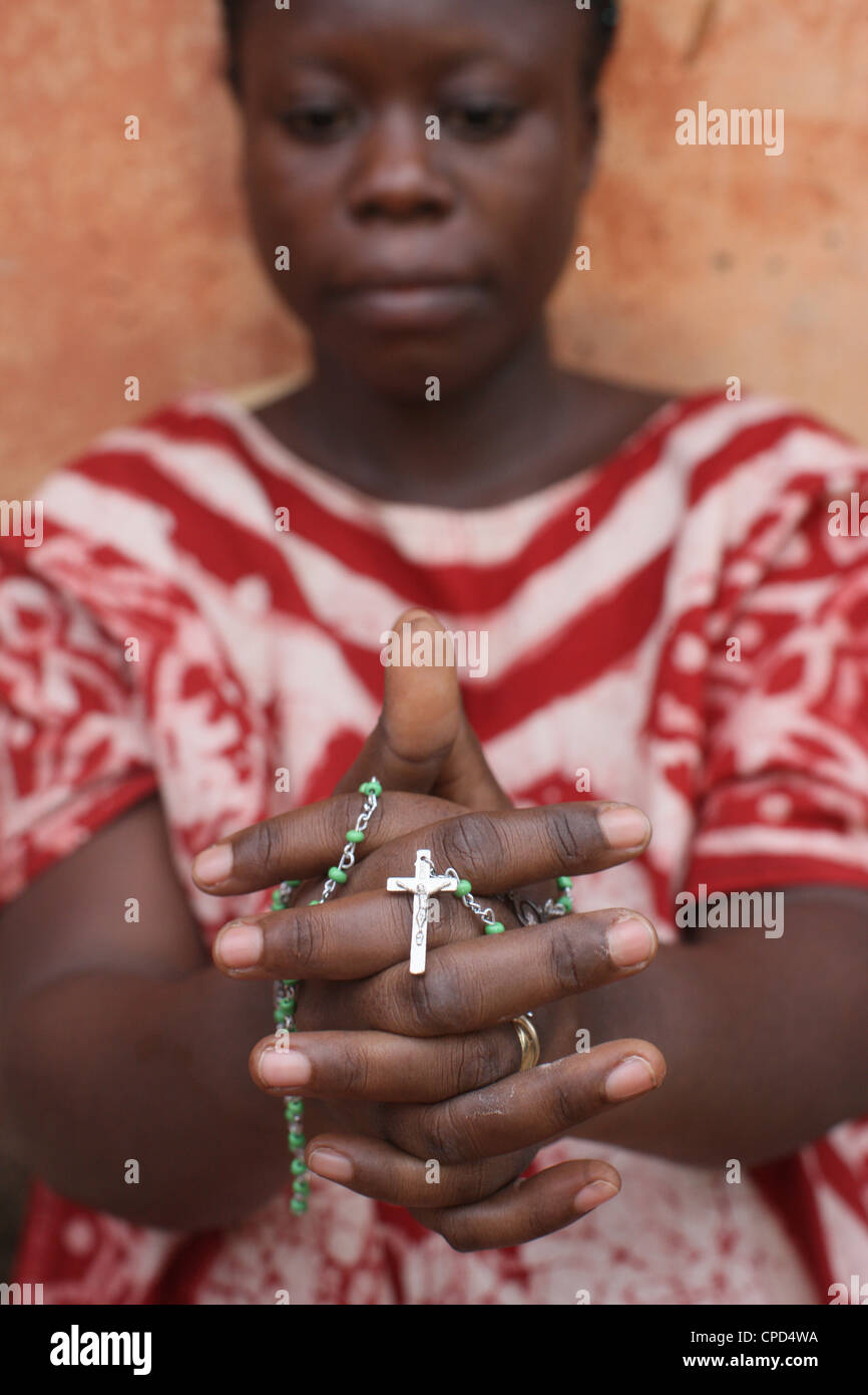 African woman praying the rosary, Lome, Togo, West Africa, Africa Stock Photo