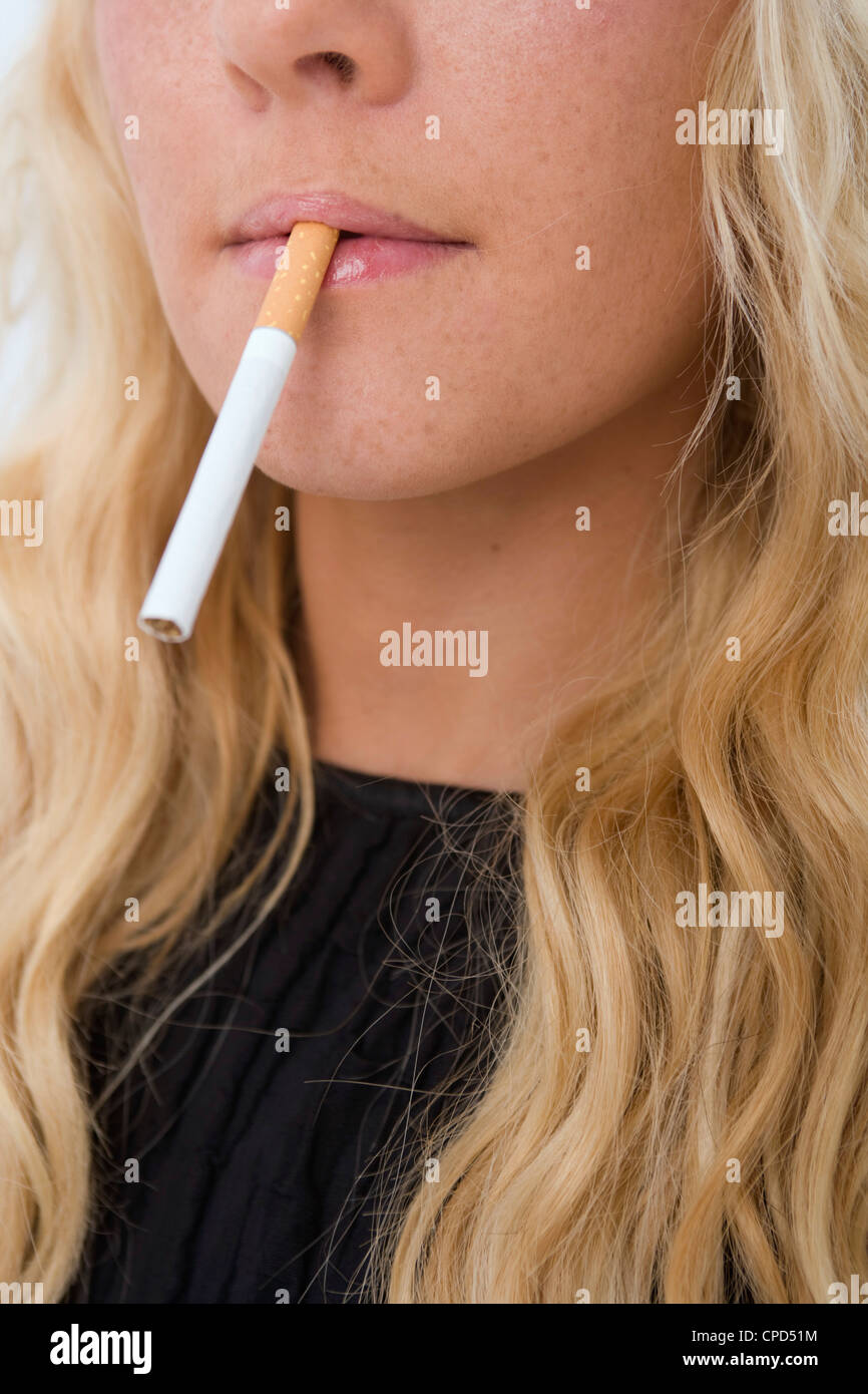 Woman with a cigarette in her mouth Stock Photo Alamy