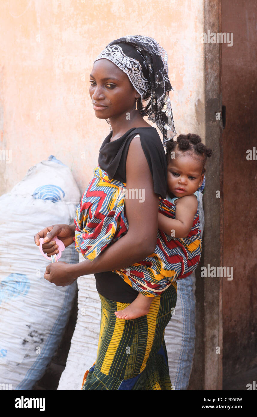 African woman carrying her baby on her back, Lome, Togo, West Africa, Africa Stock Photo