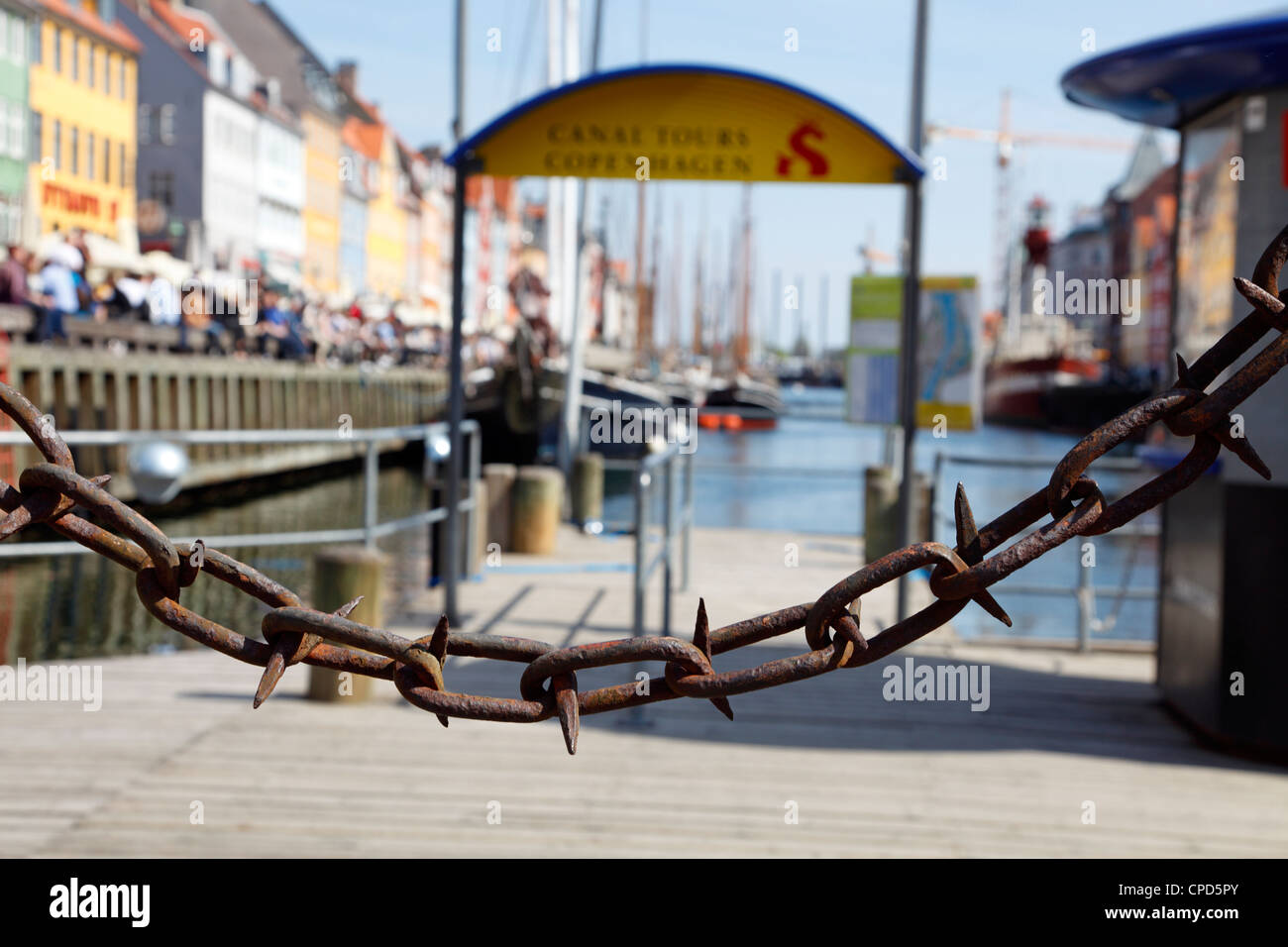 No entry at the Canal Tours in Nyhavn, port of Copenhagen, Denmark. A spiked and rusty chain is blocking this entrance. Stock Photo