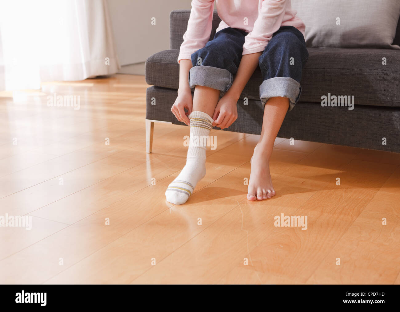 Child taking off sock Stock Photo Alamy