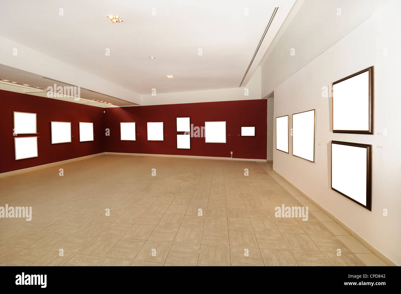 A view of modern art gallery space with blank canvas on red wall Stock Photo