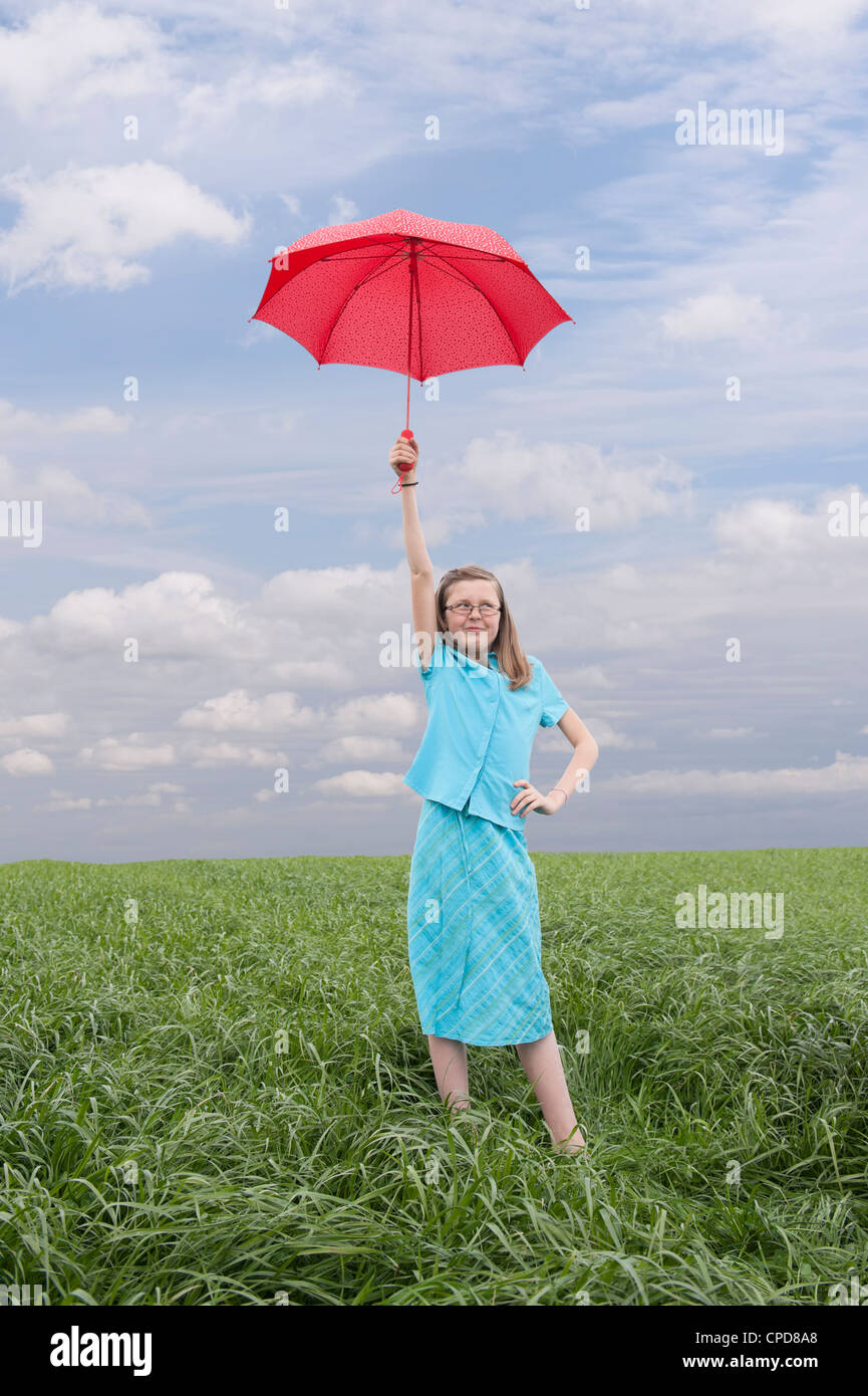 girl with red umbrella outdoors in meadow Stock Photo Alamy