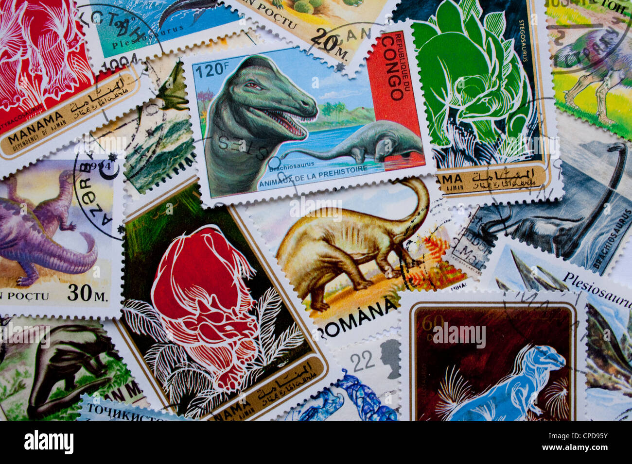 A collection of dinosaurs stamps from different countries, such as