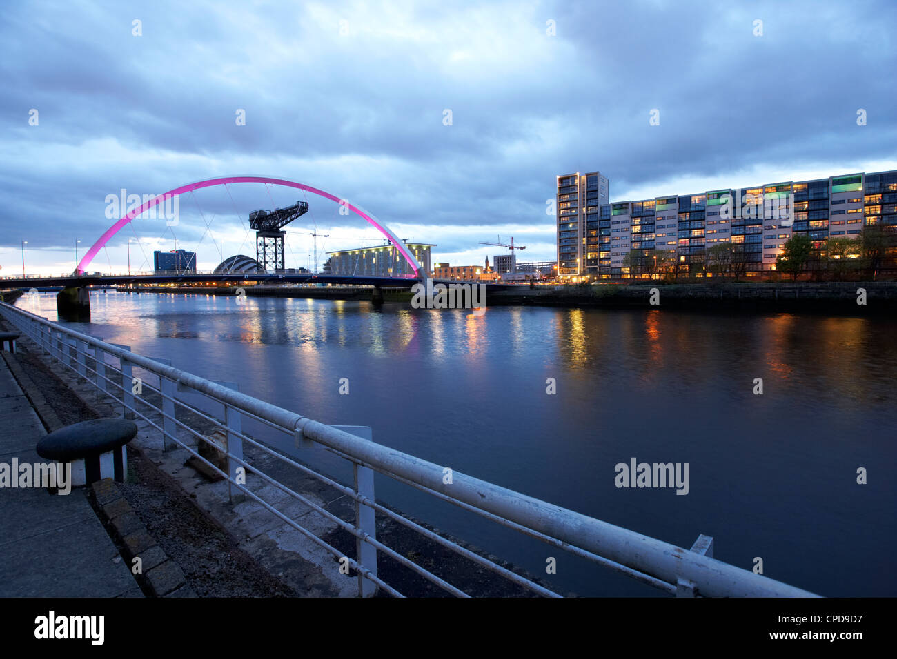 riverside walkway by the Clyde Arc bridge over the river clyde at dusk in Glasgow Scotland UK Stock Photo