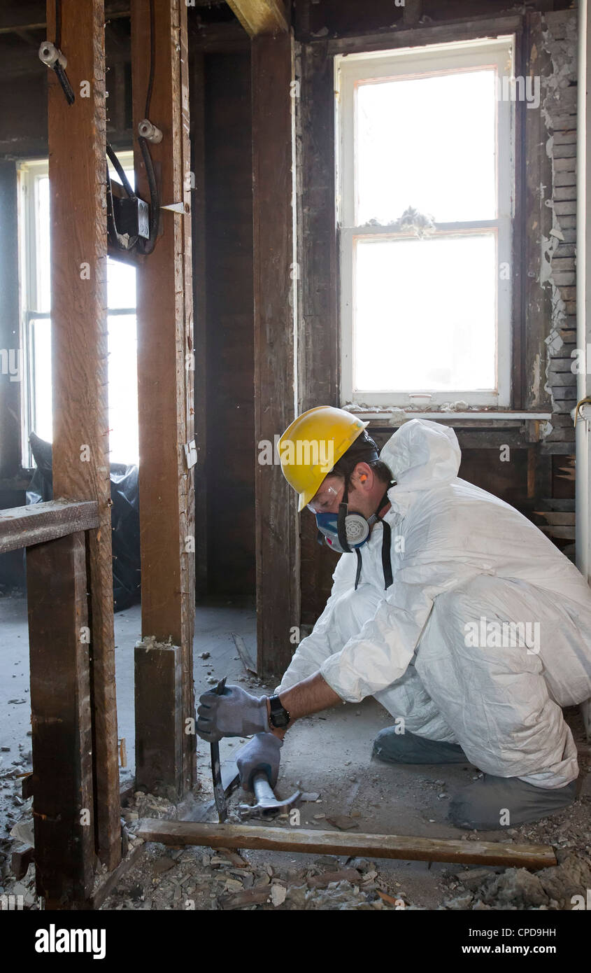 Workers salvage building materials from a home being "deconstructed