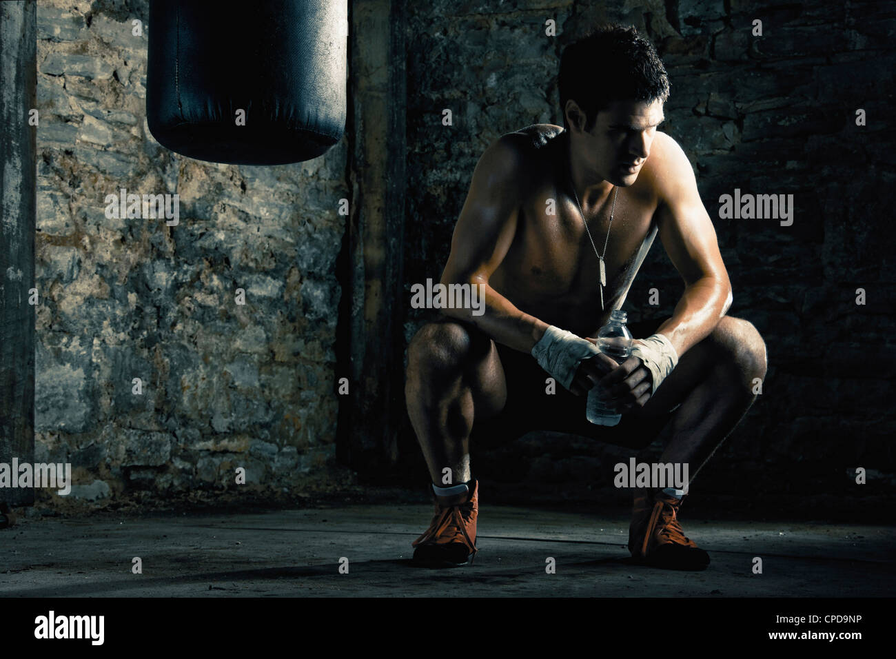 Caucasian boxer drinking water after training Stock Photo - Alamy