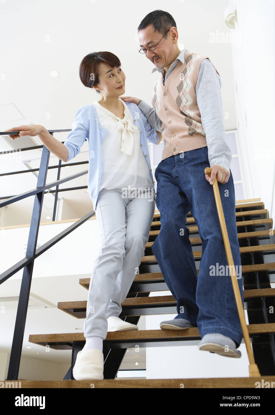 Senior couple going down stairs Stock Photo Alamy