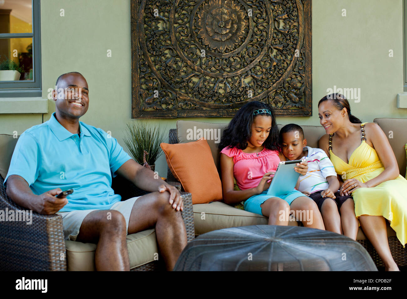 African American family relaxing in living room Stock Photo Alamy
