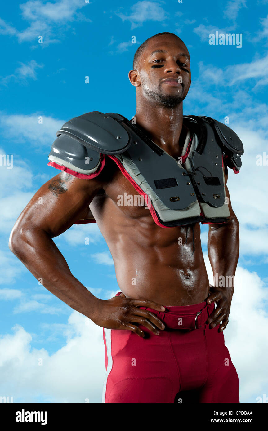 Black football player in shoulder pads Stock Photo Alamy