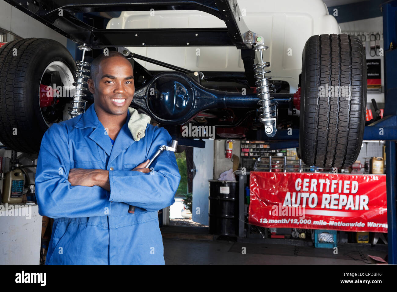 Black mechanic working on car Stock Photo Alamy