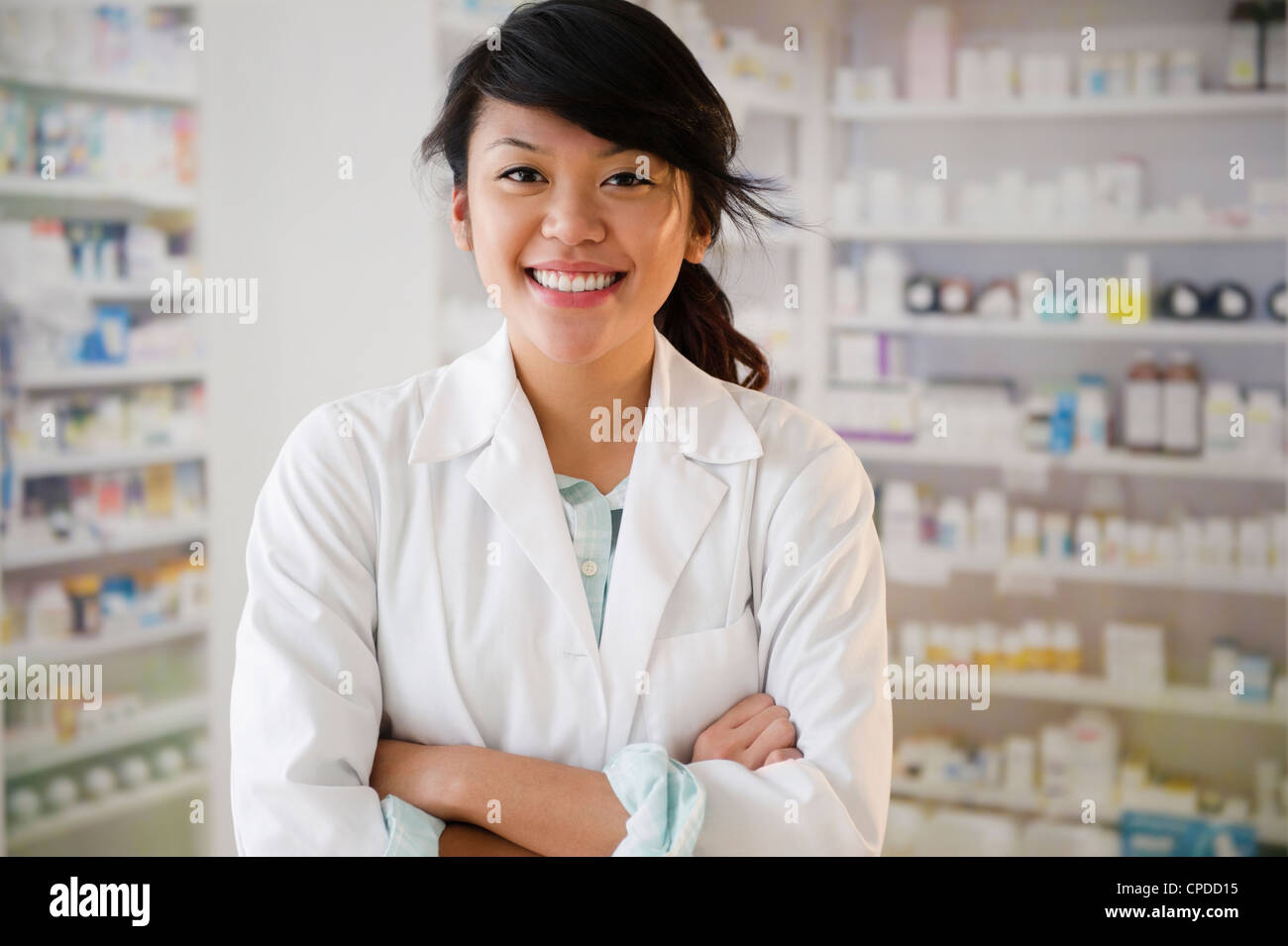 Pacific Islander pharmacist standing in pharmacy Stock Photo