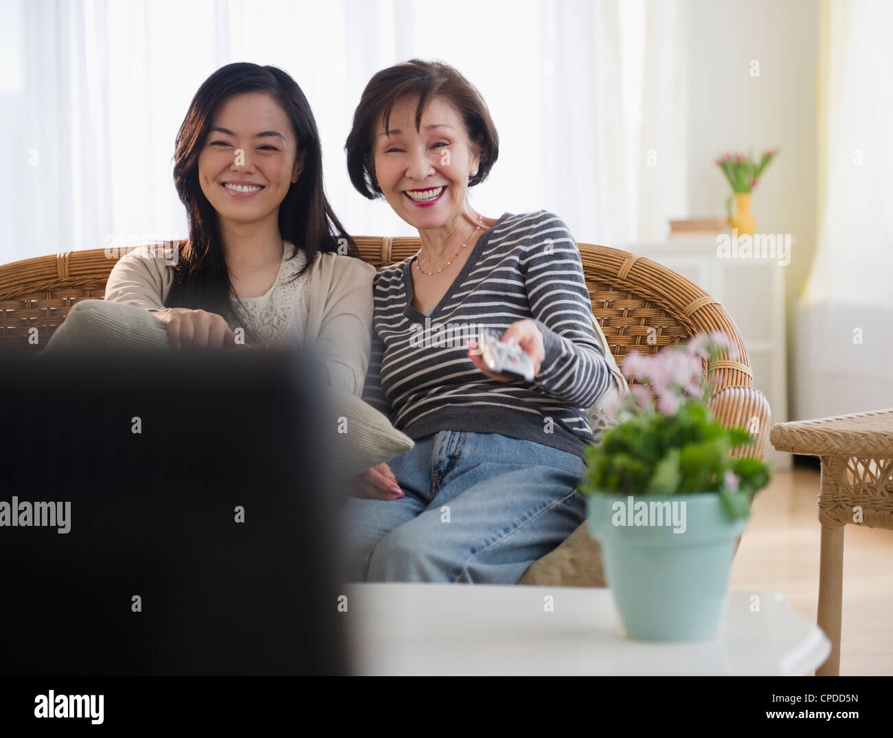 Japanese mother and daughter watching television Stock Photo
