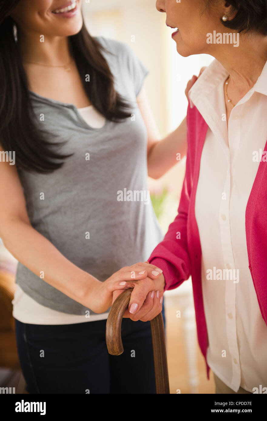 Japanese daughter helping mother walking with cane Stock Photo