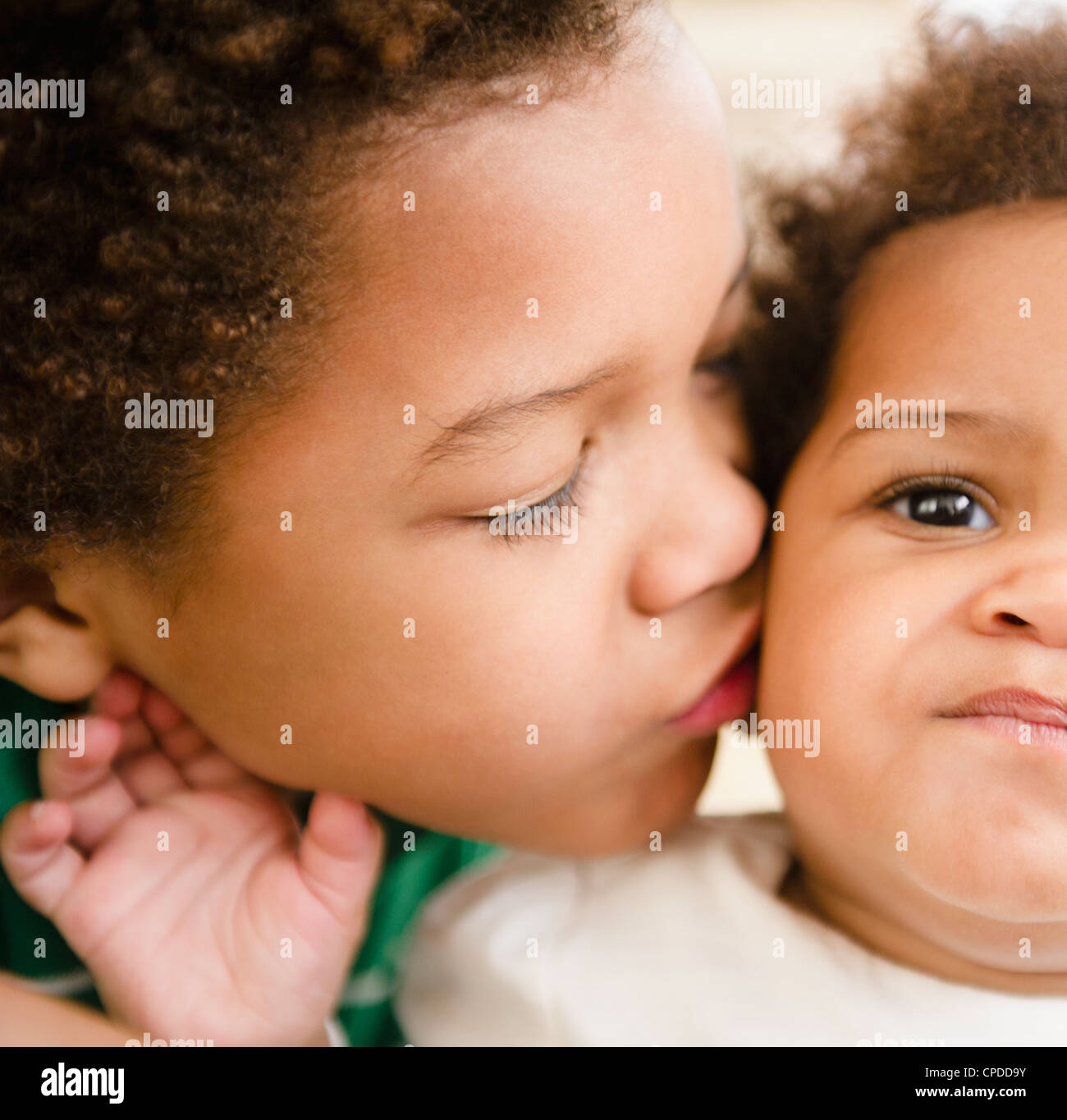 Black boy kissing sister Stock Photo