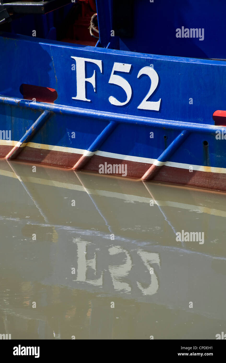 F52 fishing boat number reflected in water Stock Photo Alamy