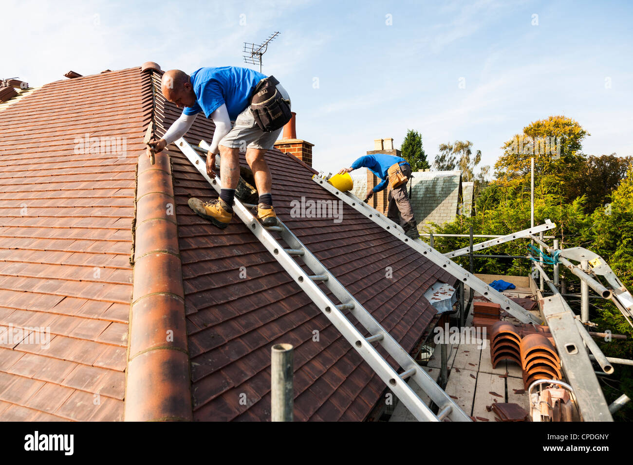 Detached house having tiles striped from roof and replacing with new ...