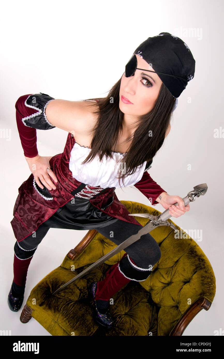 A pirate woman with an eye patch shows her sword Stock Photo