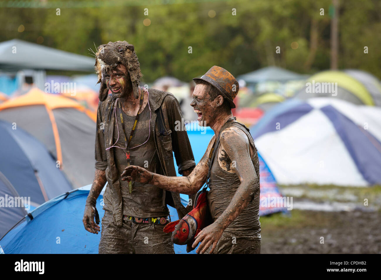 Boys playing in mud at music festival in the UK Stock Photo