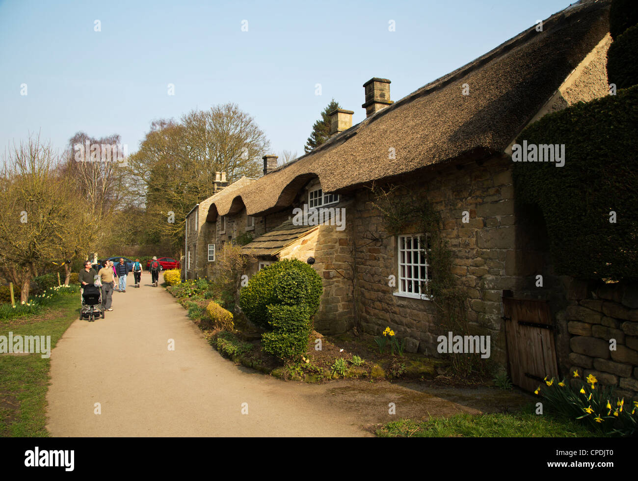 people looking at thatched roof cottages near Baslow Derbyshire village ...