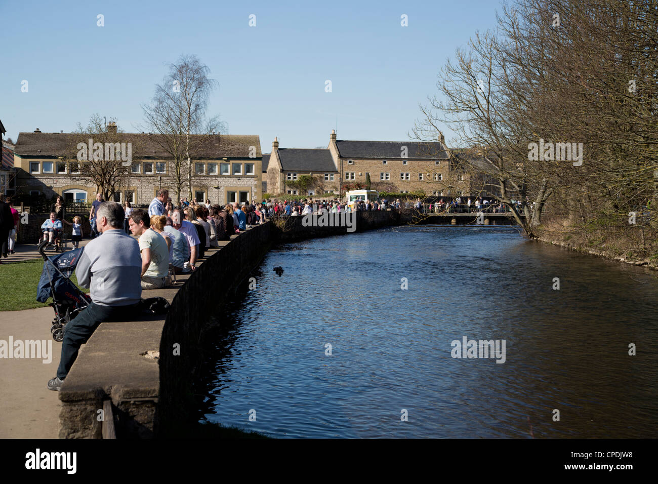 people enjoying fine weather in Bakewell on the River Wye Derbyshire