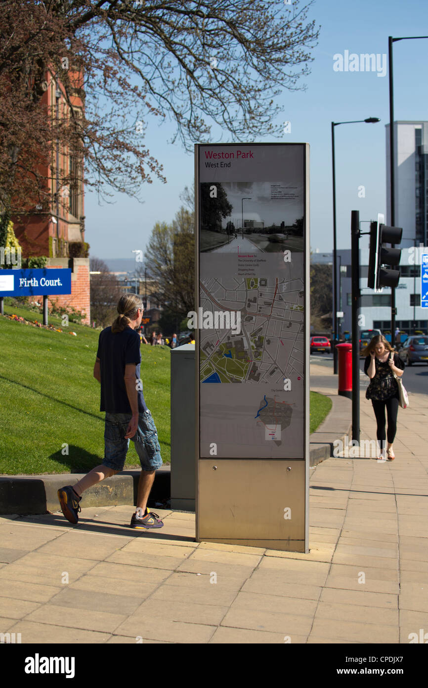 Large information sign with map and directions in middle of footpath Sheffield South Yorkshire England Stock Photo