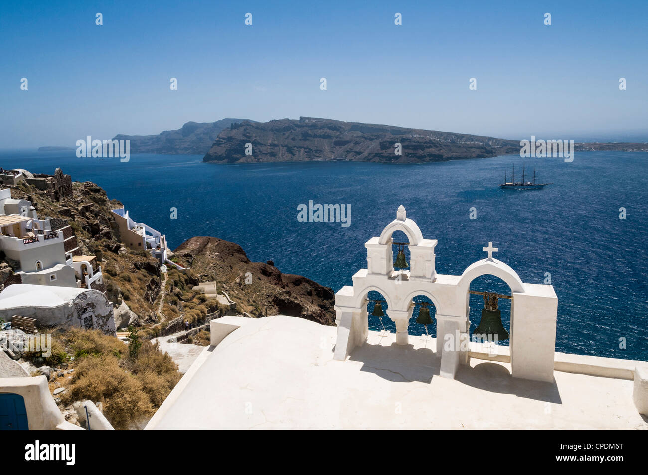 Bells of a Church in a village on the Greek Island of Santorini, Greece with a view of the caldera Stock Photo