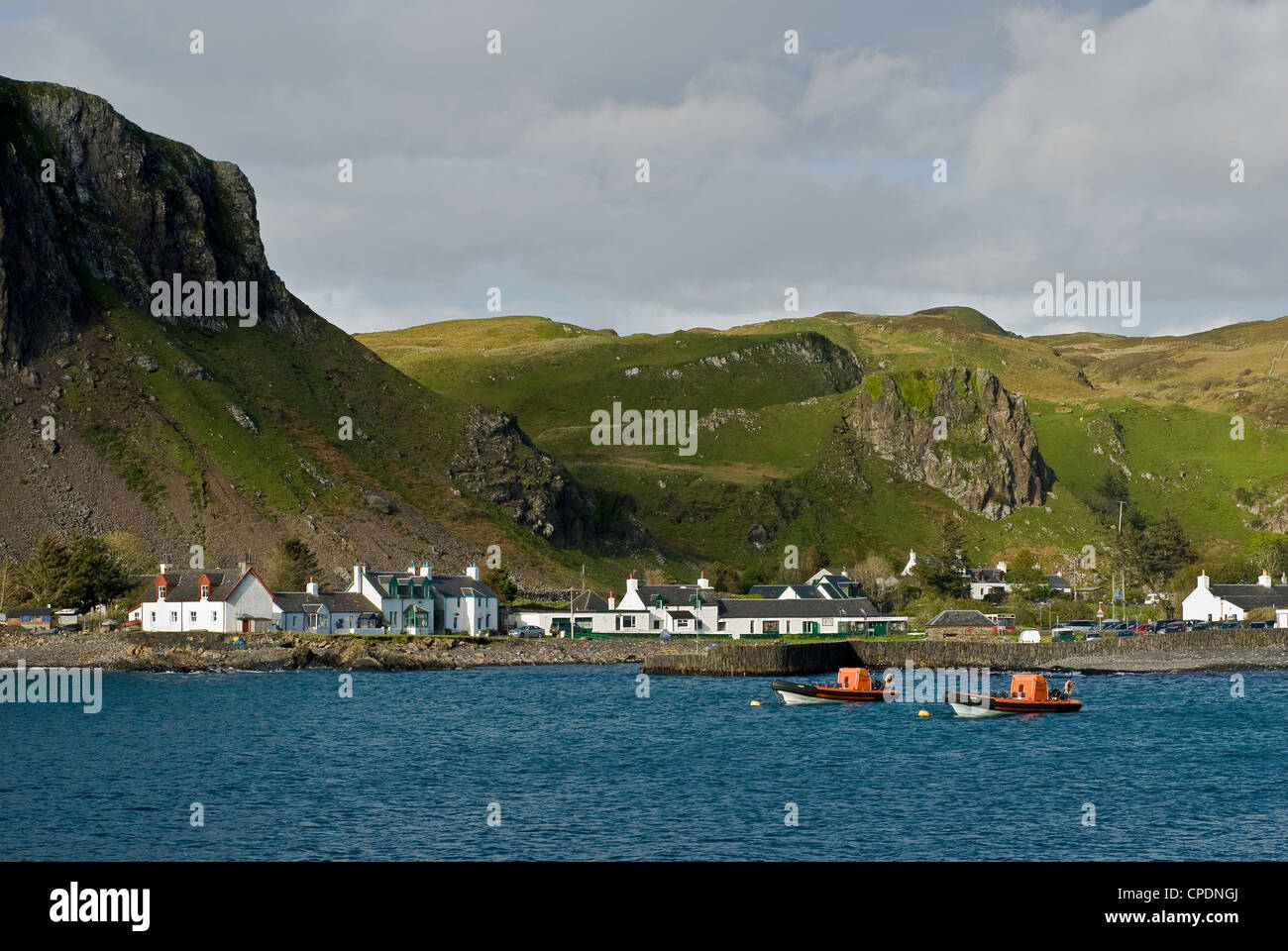 Mountain sides behind village of Ellenabeich with Ribs belonging to Seafarie, a scenic tour company based on the slate island of Easdale. Stock Photo