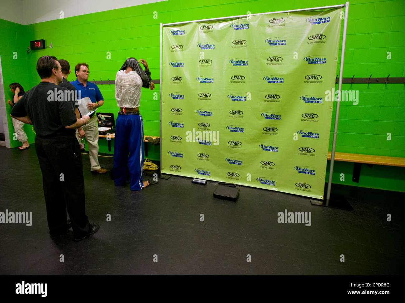 Mixed Martial Arts fighter taking off sweat suit prior to weighin