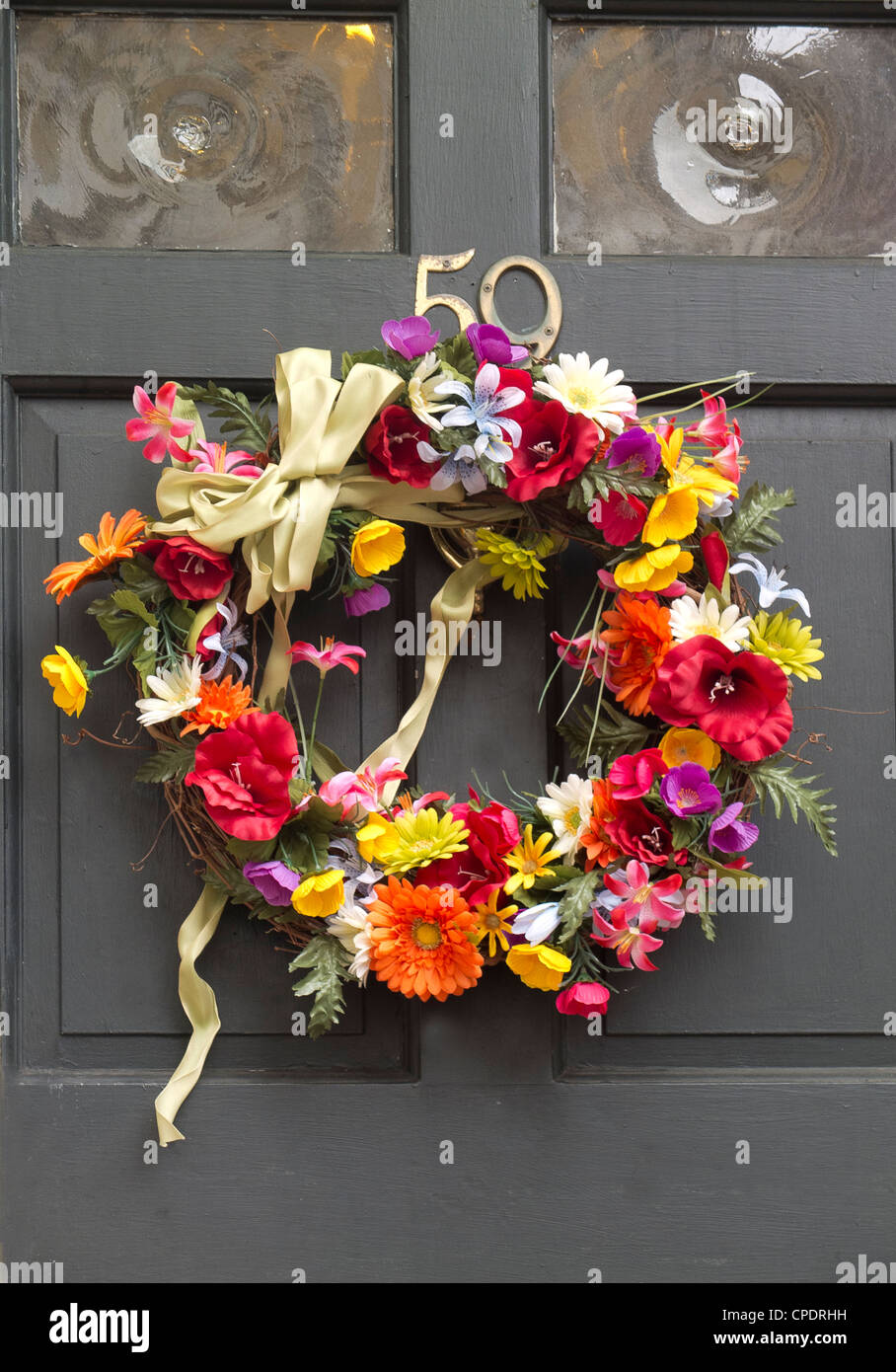 faux flower wreath on front house door Stock Photo Alamy