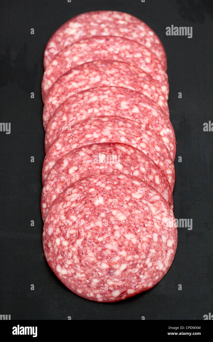 Slices of Danish Salami on black background Stock Photo Alamy