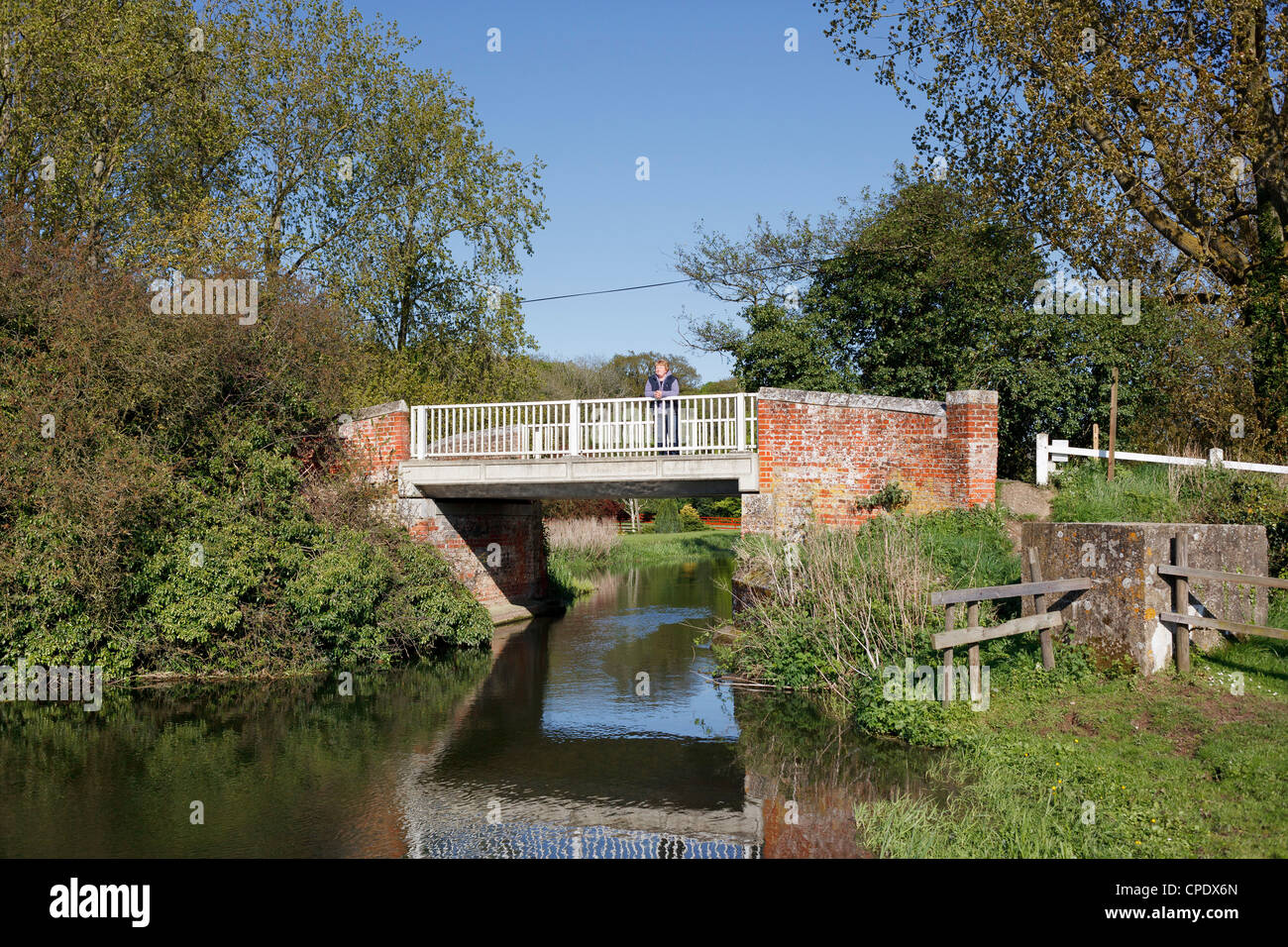 A woman looks out from the bridge over the 