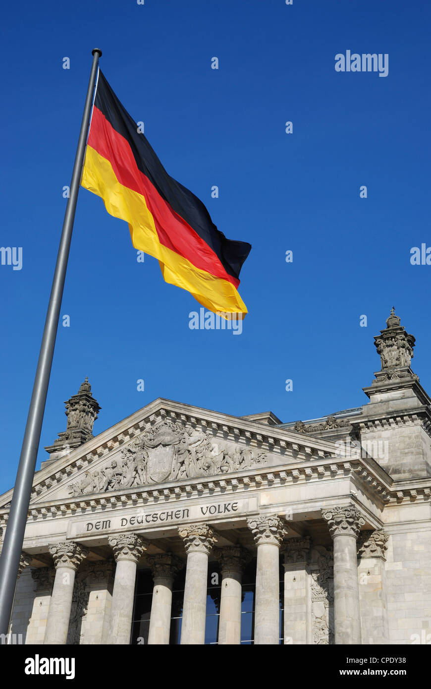 The German flag in front of the Reichstag building, Berlin, Germany. Stock Photo