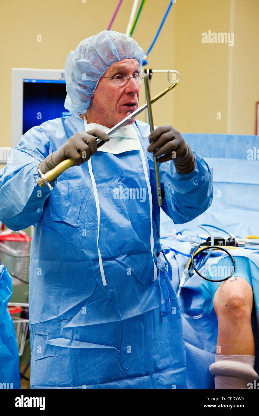 Dr. Robert Hunter, MD, orthopedic surgeon, demonstrates a simulated arthroscopic knee sugery to visitors during an open house. Stock Photo