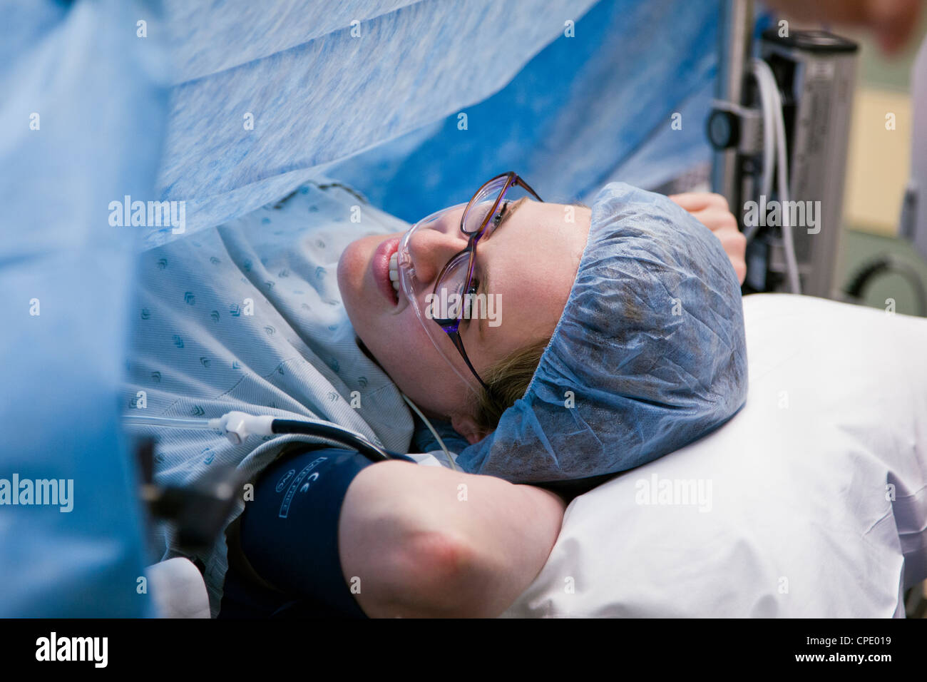 Female patient on an operating room table in a hospital surgical suite Stock Photo